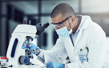 Image showing Serious young male scientist working on scientific cure for covid in a lab. Professional man in science at work during pandemic on a medical mission, thinking and vision for a vaccine for the virus.