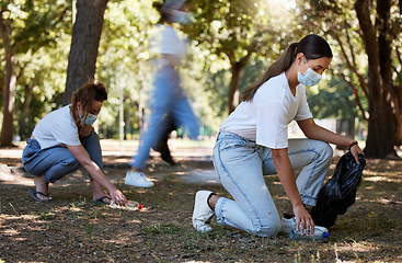 Image showing Cleaning park, community service and volunteer workers helping pick up trash and plastic bottles in care of environment. Support team of casual activists recycling, working together to end pollution