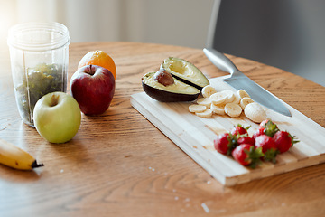 Image showing Cooking, preparing and making fruit smoothie, drink and salad in home kitchen for healthy breakfast, meal and snack. Closeup of apples, strawberries and avocado with banana for vitamins and nutrition