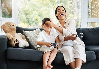 Image showing Mother and son playing video games, having fun and enjoying quality time together. Cheerful, bonding and carefree child and parent using a gaming console or interactive modern technology