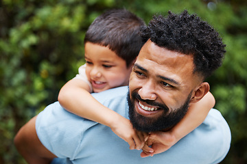 Image showing Happy father with son on piggyback while smiling, laughing and playing in a park outdoors. Cheerful, loving and caring dad relaxing, bonding and enjoying fun day with playful, cute and adorable boy