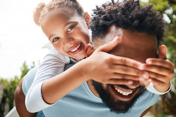 Image showing Happy, playful and carefree dad and daughter playing outdoors in the park and child covering fathers eyes. Portrait of an excited, joyful and cheerful child having fun with her parent in nature