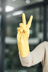 Image showing Peace sign, carefree, and hand gesture while cleaning, doing chores and housework alone at home. Closeup of fingers of a cleaner counting, expressing happiness and enjoying a hygiene task