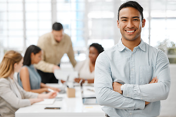 Image showing Smiling, happy and proud young business man with arms crossed showing great leadership to his team in an office. Portrait of a confident entrepreneur satisfied with new opportunity in a startup