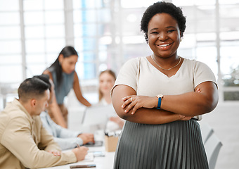 Image showing Motivated, confident and happy female leader standing with her arms crossed in the boardroom with colleagues in the background for a meeting. Portrait of a business woman with a positive mindset