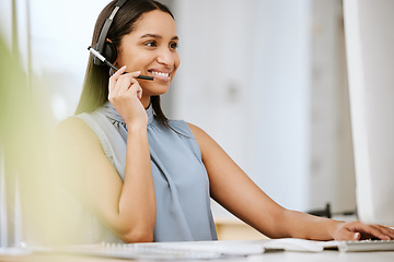 Image showing Call center agent, business consultant or telemarketer assisting client online using headset while typing at computer desk. Contact us for excellent customer service or online faq helpdesk support.