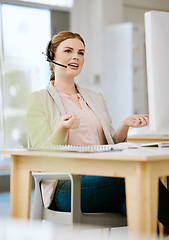 Image showing Insurance agent, call center or contact support employee giving good customer service via her headset at her help desk at work. Female advisor consulting and helping via her headset talking about us