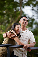 Image showing Stylish, loving and carefree couple bonding and hugging showing affection in the park. Happy, cheerful and romantic african american couple embracing each other while standing and laughing outdoors