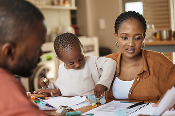 Image showing Busy, tired and multitask mother working while taking care of her child at home. African american entrepreneur or freelancer analyzing paperwork with her husband while holding her busy and cute son