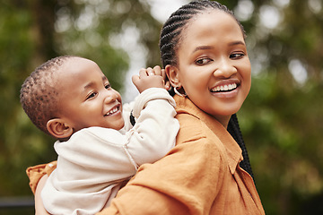 Image showing Happy mother bonding with cute baby boy on piggyback while smiling, laughing and having fun play in a park outdoors. Cheerful, loving and caring mom relaxing with playful, cute and adorable child