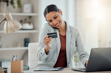 Image showing Ecommerce, online shopping and secure banking of happy woman reading credit card while talking on the phone and using laptop. Smiling entrepreneur doing safe financial transaction or transfer payment