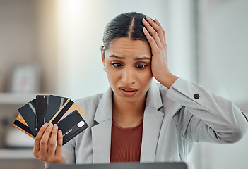 Image showing Finance, debt and credit with a business woman suffering from worry, stress and anxiety of inflation in the economy. Young female holding bank cards and having problems while trying to pay an account