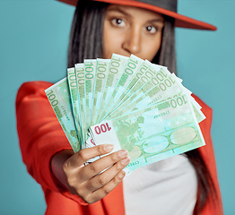 Image showing Rich, wealthy and stylish woman showing her money and success in fashion posing over copy space. Fashionable female advertising a cash prize or lottery win from a competition