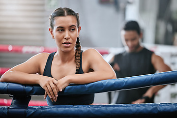 Image showing Fit, active and tired boxer taking break, resting and breathing after workout, training and exercise with boxing coach in ring. Sporty, athletic or strong woman after kickboxing fight or sports match