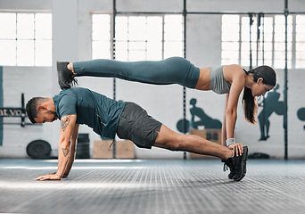 Image showing Strength, active and fit couple exercising, training or doing workout exercise routine inside gym or sports center. Athletic, fitness man and woman balancing together in a physical endurance session