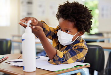 Image showing Student applying sanitizer in school class for hygiene, clean hands and to protect from spread of covid and cold germ. Afro child or little boy learning and getting education in corona virus pandemic