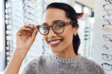 Image showing Woman wearing pair of trendy glasses, stylish spectacles and new prescription lenses at an optometrist. Portrait of a customer choosing, buying and shopping for frames for better vision and eyesight