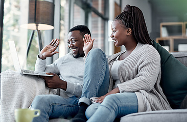 Image showing Happy couple waving while talking on video call and online chat on a laptop webcam in a lounge at home. Smiling man and woman having conversation while connecting with virtual contact on the internet