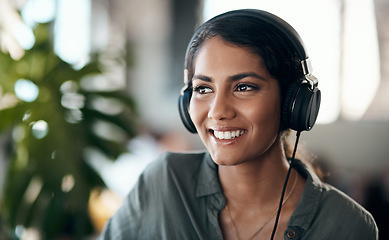 Image showing Happy face of young woman listening to music on headphones, happy and relaxed at home. Female smiling while spending her free time enjoying an audio book or learning a new language on the weekend