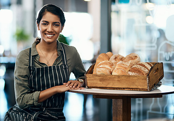 Image showing Portrait of a female restaurant waiter, baker or coffee shop retail manager with fresh bread for breakfast. Smiling, happy and young woman bakery worker ready to welcome a customer and work in a cafe