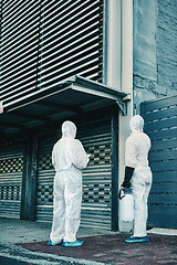 Image showing Medical team and covid hygiene healthcare workers wearing hazmat suits for safety while at quarantine site outside. In protective gear for cleaning, disinfection and decontamination to fight virus