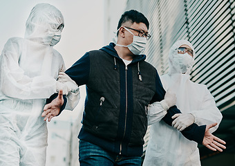 Image showing Man breaking covid regulation getting taken away or arrested by healthcare workers wearing hazmat protective suits. Male removed for not following the rules or restrictions of coronavirus pandemic.