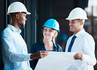 Image showing Architect, engineer and building contractor looking at plans or blueprints while talking and discussing strategy. Team or group of builders looking motivated and ready to develop, renovate or remodel