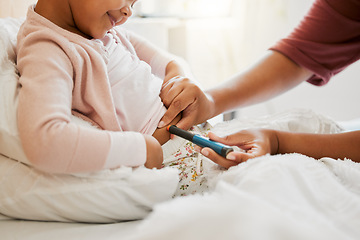Image showing Testing glucose, blood pressure and diabetes of little girl with insulin treatment in bed at home. Mother checking health, wellness and blood sugar medical measurement of her daughter in a bedroom