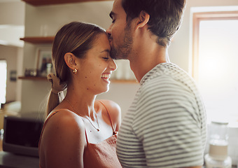 Image showing Affectionate, loving and romantic couple in a happy relationship together in the kitchen at home. Man and woman sharing a moment of happiness, romance and bonding with each other in love.