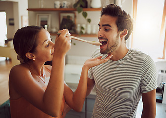 Image showing Fun, bonding and a couple cooking in a kitchen at home, enjoying free time on weekend. Young girlfriend and boyfriend learning to cook together while being playful, having fun with their relationship