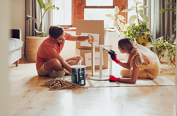 Image showing Couple painting wooden table by recycle, donate and thrift furniture for a new home improvement project in new apartment. Creative and DIY man and woman with reusable objects, decorating their house