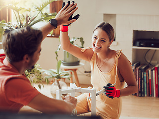 Image showing Couple doing high five, well done or good job gesture while painting or remodelling furniture, wooden table for home improvement or interior decor. A man and woman with fun, creative DIY activity