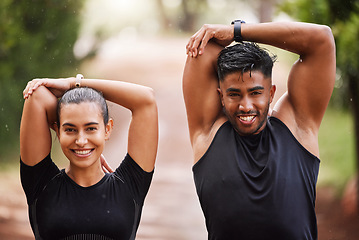 Image showing Healthy, fit and motivated couple stretching, warming up or training together in green park with bokeh background. Faces of athletic man and woman preparing for endurance workout, warmup or exercise