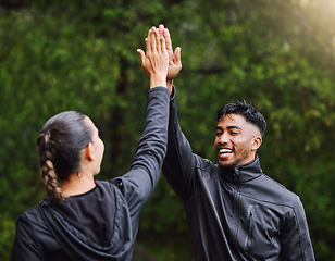 Image showing Active, fit and sporty athletes doing a high five to celebrate and congratulate on fitness goals. Healthy, happy and exercising couple motivated after training, getting cardio workout outside