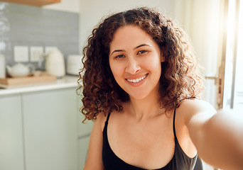 Image showing Fun, happy and stylish woman taking a selfie for social media, dating app and online blog while relaxing at home. Portrait of relaxed lady on video chat, filming livestream or blogging from kitchen