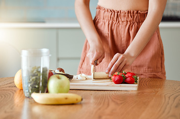 Image showing Woman making healthy smoothie for energy, nutrition and wellness with fresh organic fruit being cut, sliced and prepared. Delicious detox drink, wholesome diet and cleanse with vitamins and nutrients