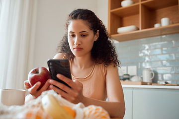 Image showing Eating healthy, diet planning and personal online female dietitian. Serious nutritionist check phone, snack on fresh fruit and concentrating on social media. Communicate with patient about calories.