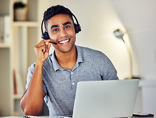 Image showing . Friendly call center, online or tech support worker who helps clients, customers and callers. Man on a laptop, with a headset and working as a customer service professional from home portrait.