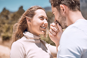 Image showing In love, romance and smiling young couple bonding on sunny summer holiday or spring vacation. Hand kissing, cheerful and trendy romantic dating and relationship partners together on getaway trip.