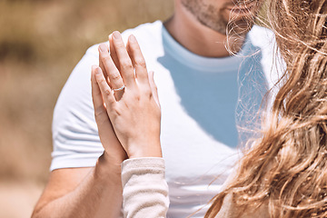 Image showing Closeup of an engaged couple holding hands showing their romance, love and care. Caucasian man and woman after a sweet, romantic and special proposal. Lady showing off her beautiful engagement ring.