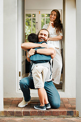 Image showing Loving dad hug and embrace son, love from father to son or parents saying goodbye to child on front porch at home. Happy family greeting little boy with mother standing in doorway or house entrance.