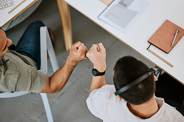 Image showing Excited call centre agents, fist bump and celebrating deal, promotion and sale from above in office. Motivated, happy and successful telemarketing colleagues or customer support operators cheering