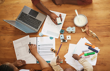 Image showing Writing and tax papers of parents with home school kid busy with remote work at a family home. Above view of a child at a table while mom and father work on finance, audit and business documents