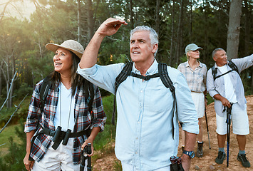 Image showing . Hiking, adventure and exploring with a group of senior friends having fun, exercising and enjoying the outdoors. Walking, discovery and journey with old people sightseeing in the forest or woods.