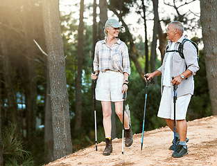 Image showing Hiking, adventure and exploring with a senior couple or friends having fun, exercising and enjoying the outdoors. Walking, discovering and journey with old people talking in nature, forest or woods