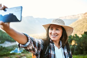 Image showing . Hiking, tourist and woman taking selfies, photo and video call for social media while exploring, travel and sightseeing in nature outdoors. Happy, active and free female enjoying scenic fresh hike.