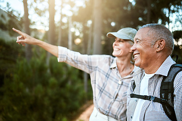 Image showing Hiking, adventure and freedom with a senior couple enjoying and exploring the forest or woods and bonding together. Happy, carefree and exploring retired man and woman looking at the views outdoors