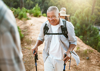Image showing Hike, trekking sticks and senior male walking with friends for fitness and health in nature. Healthy, active and smiling mature man hiking with a backpack. Old group on an outdoor wellness adventure