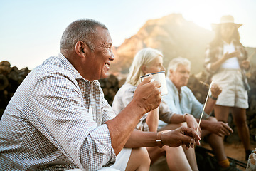 Image showing . Relaxed senior camping with friends, taking a break and drinking a cup of coffee while enjoying retirement keeping healthy outdoors in nature. Smiling retired man on a getaway wellness retreat.