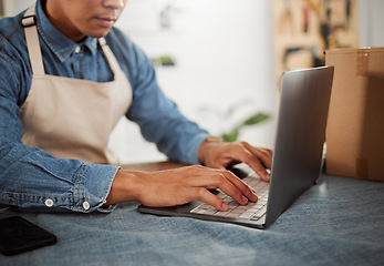 Image showing Fashion designer typing on laptop, browsing online order and searching trendy, fashionable and stylish clothes inspiration. Closeup tailor or seamstress hands with tech in workshop, boutique or store